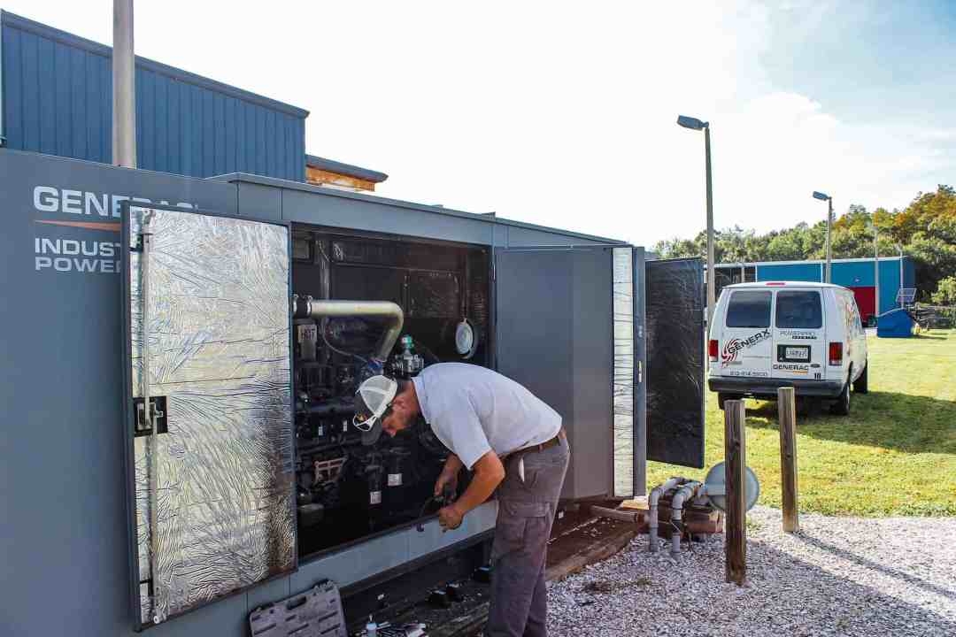 Expert technician installing a Generac commercial generator, highlighting professional service and installation<br />
