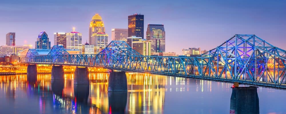 The Louisville skyline at dusk, behind the Ohio River bridges
